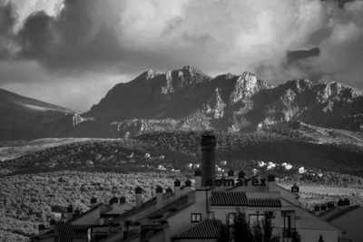 High angle view of townscape and mountains against sky