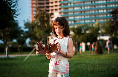 Little girl having fun outdoors in sunset