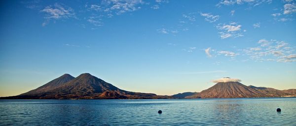 Scenic view of lake against cloudy sky