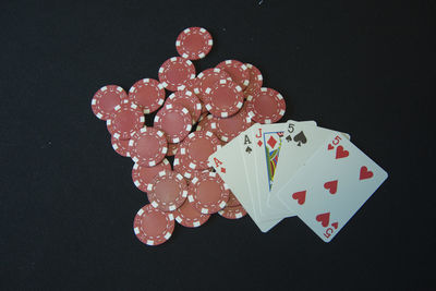 Close-up of heart shape on table against black background