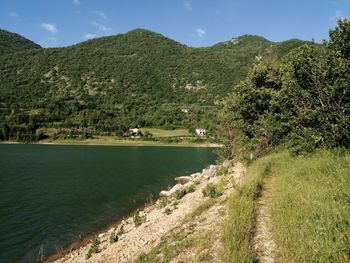 Scenic view of land and mountains against sky