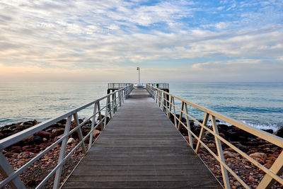 Pier over sea against sky