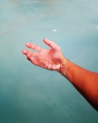 Close-up of person hand in water