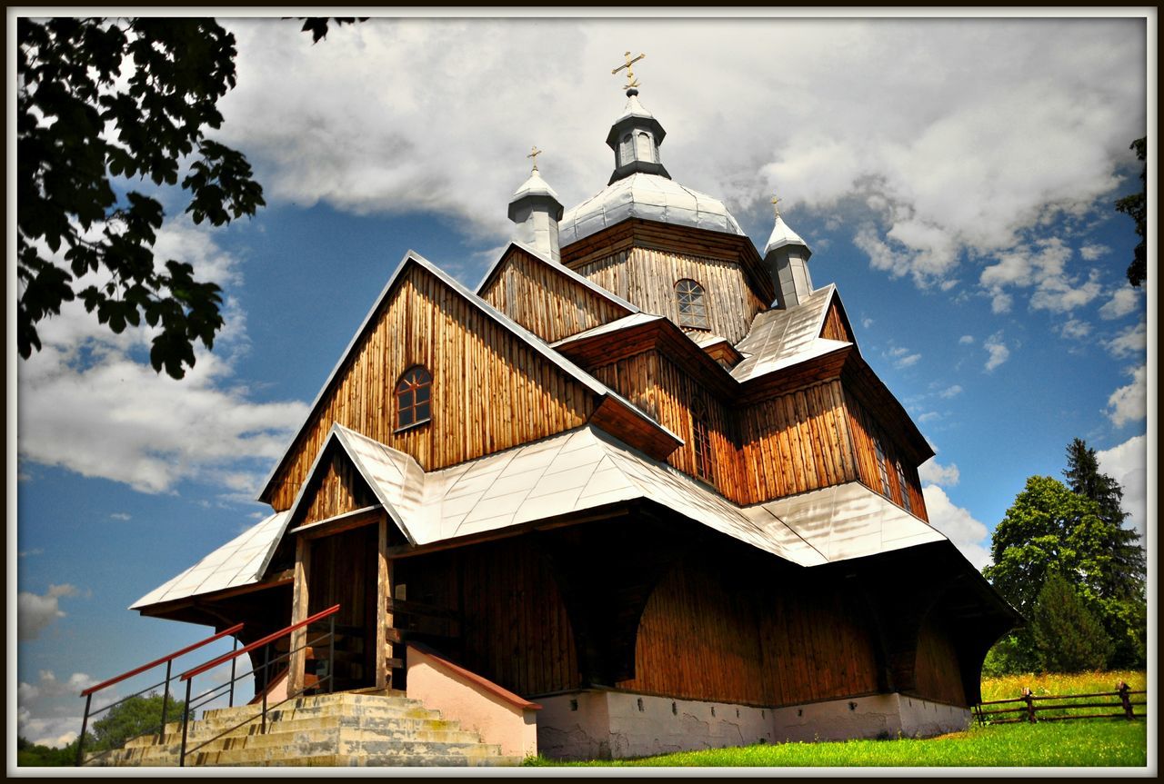 building exterior, architecture, built structure, sky, place of worship, religion, transfer print, church, spirituality, low angle view, cloud - sky, auto post production filter, cloud, tree, cross, cloudy, roof, day