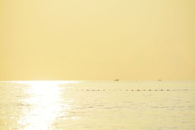 Scenic view of sea against clear sky during sunset