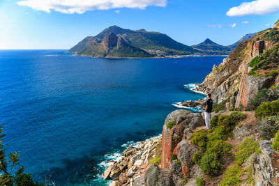 Scenic view of sea and mountains against sky