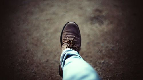 Low section of person walking on street