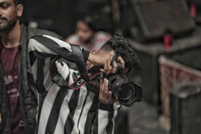 Portrait of young man photographing