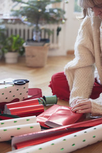 Woman's hands packing christmas presents