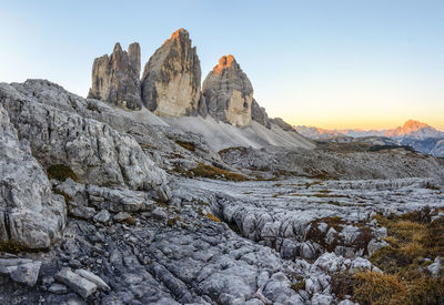 Scenic view of rocky mountains against sky during sunset