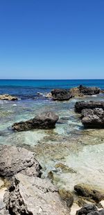 Scenic view of sea against clear blue sky