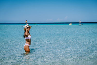 Full length of woman in sea against sky