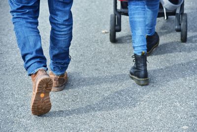 Low section of people walking on road