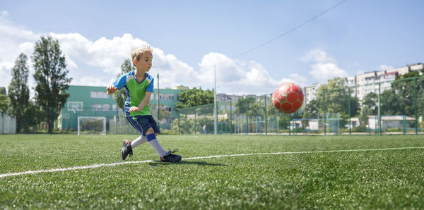 Children playing soccer on field