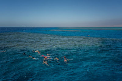 View of swimming in sea against clear sky