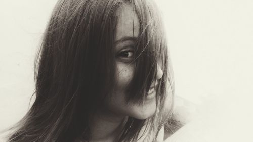 Close-up portrait of woman against white background