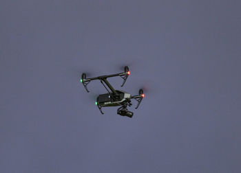 Low angle view of helicopter against clear sky