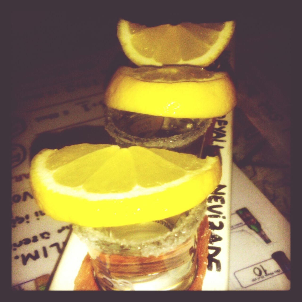 food and drink, indoors, drink, still life, freshness, yellow, refreshment, table, drinking glass, close-up, glass - material, food, healthy eating, fruit, no people, drinking straw, lemon, alcohol, transparent, focus on foreground