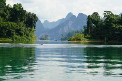 Scenic view of lake and mountains against sky