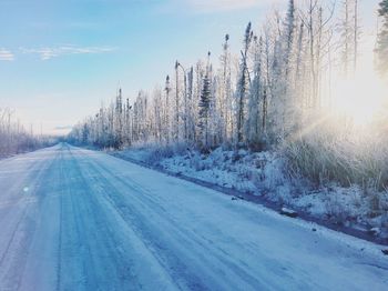 Snow covered road against sky