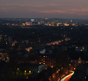 Illuminated cityscape against sky at night