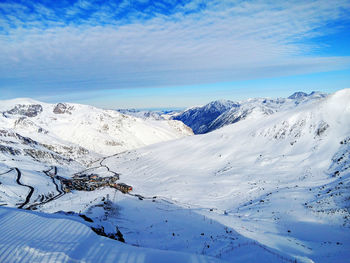 Scenic view of snowcapped mountains against blue sky