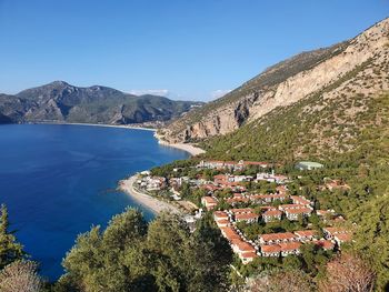 High angle view of resort,  sea and mountains against clear sky