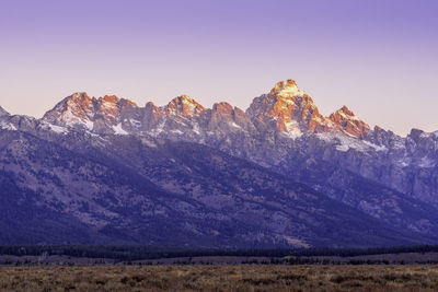 Scenic view of snowcapped mountains against clear sky