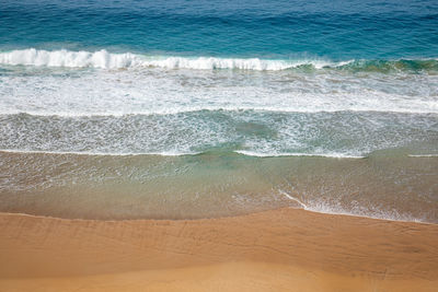 High angle view of surf on beach