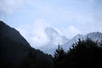 Scenic view of mountains against cloudy sky