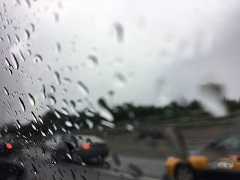 Close-up of wet car window in rainy season