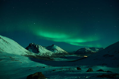 Scenic view of snowcapped mountains against sky at night