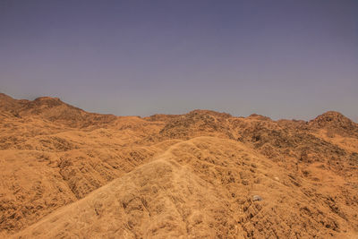 Scenic view of desert against clear sky