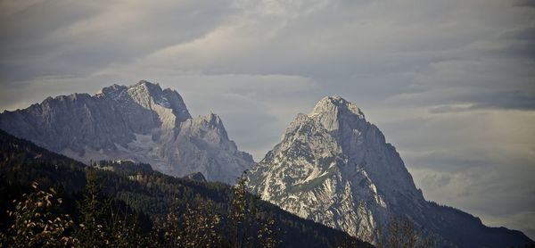 Low angle view of snowcapped mountains against sky