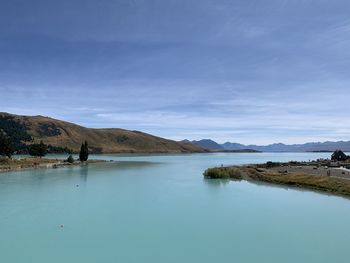 Scenic view of lake against blue sky