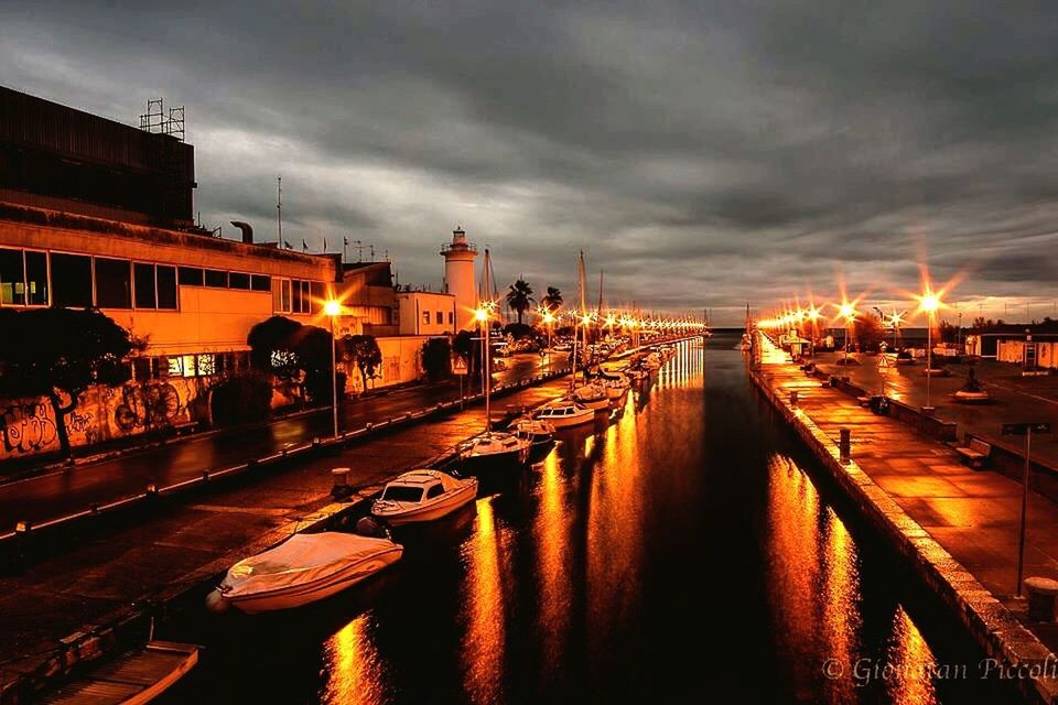 building exterior, architecture, built structure, illuminated, sky, water, sunset, transportation, city, cloud - sky, street light, canal, river, dusk, reflection, street, waterfront, city life, night, mode of transport