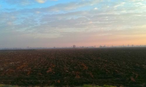 Scenic view of landscape against sky during sunset