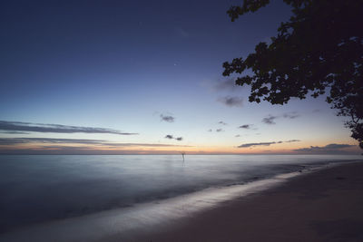 Scenic view of beach against sky during sunset