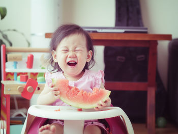 Portrait of happy girl eating watermelon