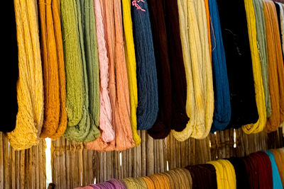 Close-up of multi colored clothes hanging at store