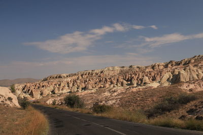 Road by mountain against sky