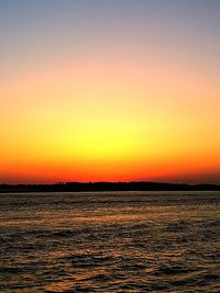 Scenic view of sea against romantic sky at sunset