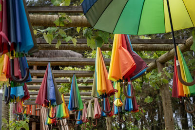 Multi colored chairs hanging on clothesline