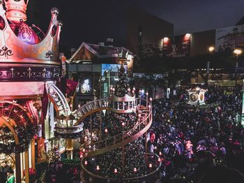 Illuminated christmas lights in city at night