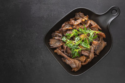 High angle view of meat on barbecue grill