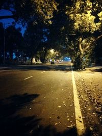 Car on road by trees against sky