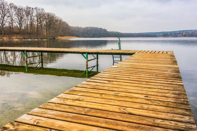 Pier over lake against sky