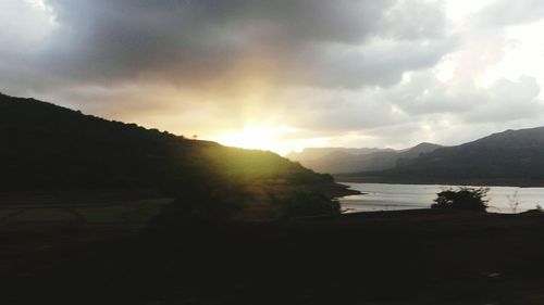 Scenic view of lake against cloudy sky