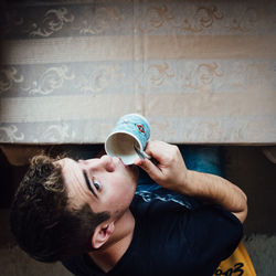 High angle view of man drinking coffee