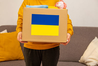 Midsection of woman holding gift box